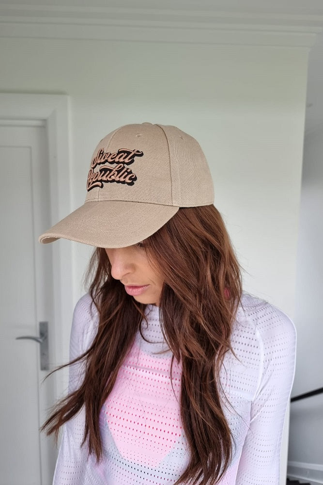 White sports cap with pink logo